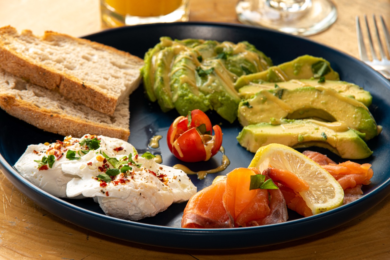 Beautiful breakfast plate with avocado, smoked salmon, and artisanal bread