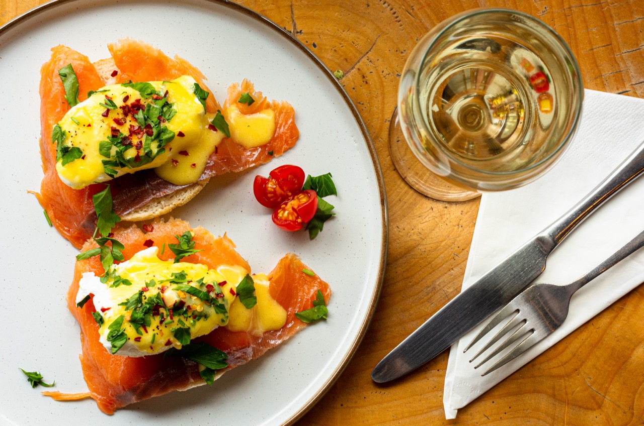 Beautifully plated salmon dish with mixed greens at Foodilic